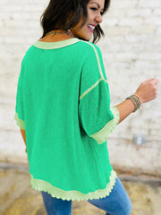 Twist ribbed t-shirt in bright green with contrast stitching and asymmetrical hem.