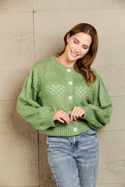 Green acrylic cropped cardigan with bubble sleeves and textured knit detail