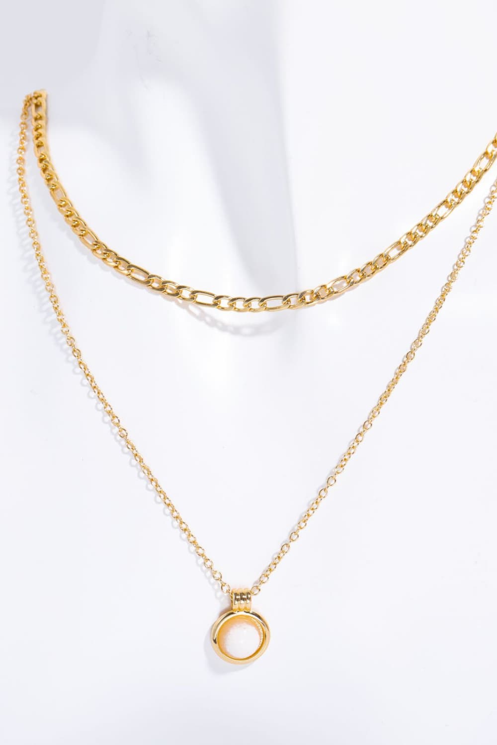 Gold layered necklace with a white aventurine orb pendant.