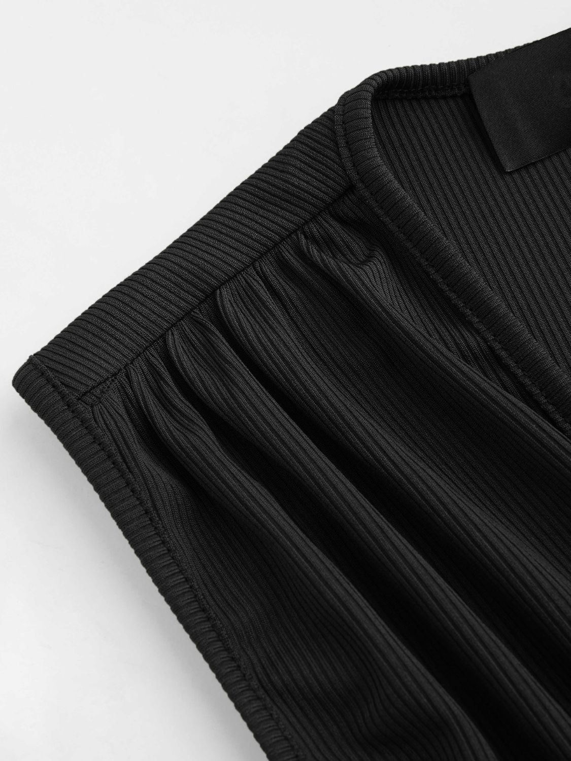 Black ribbed plunge romper with gathered detail at the neckline.