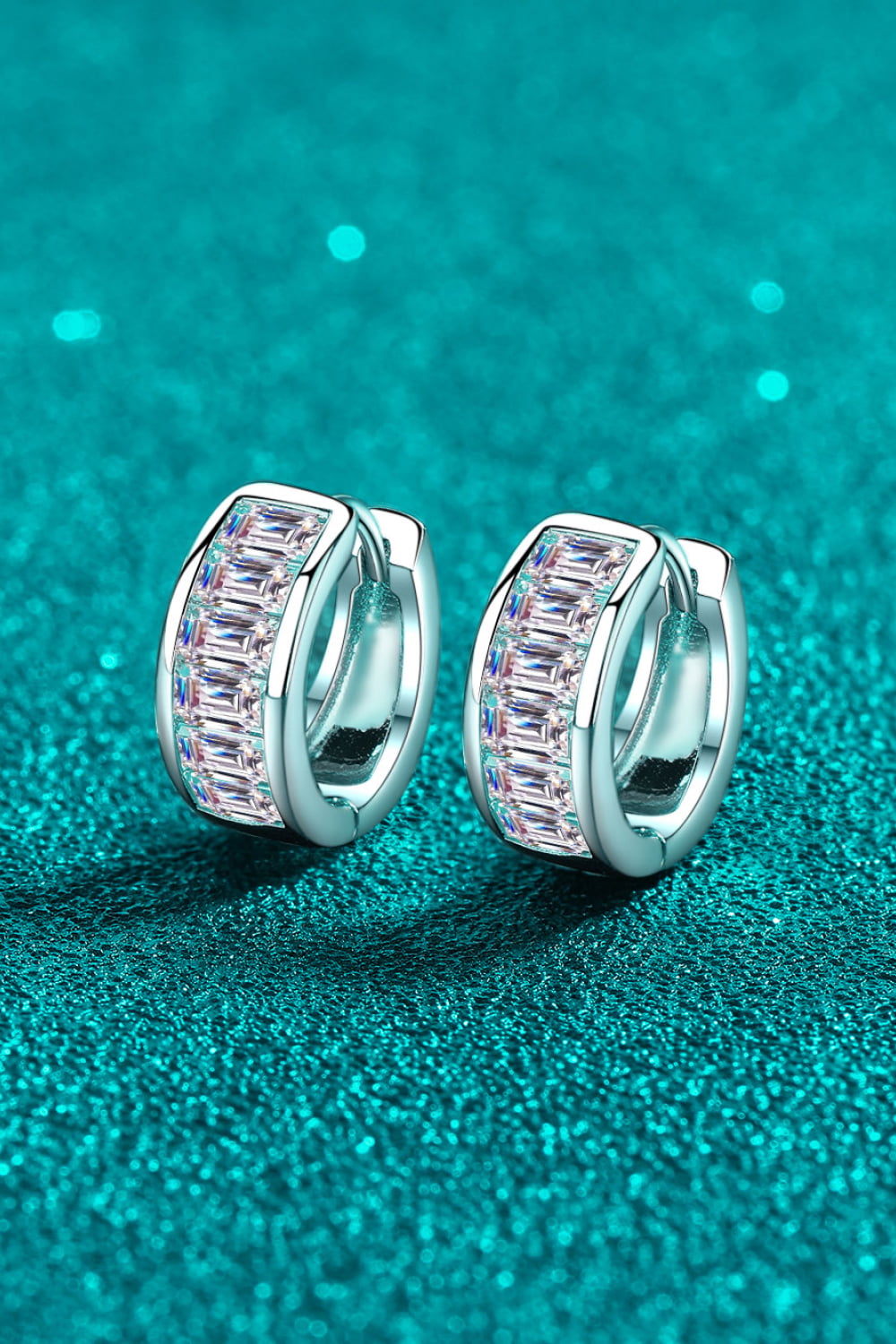 Silver baguette cut crystal huggie hoop earrings with a row of sparkling crystals.