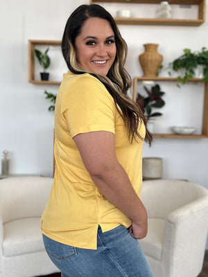 Yellow v-neck t-shirt with short sleeves and asymmetric hemline