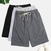 Relaxed culotte lounge shorts in black, light gray, and dark gray with drawstring waists.