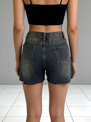 Dark wash denim shorts with frayed hem and distressed details