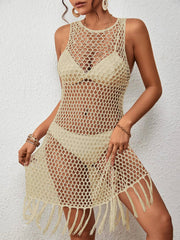 Open-knit beach cover-up dress in cream with fringe hem and sleeveless design.