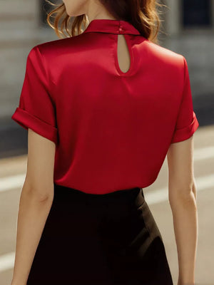 Scarlet satin blouse with keyhole neckline and cuffed short sleeves.