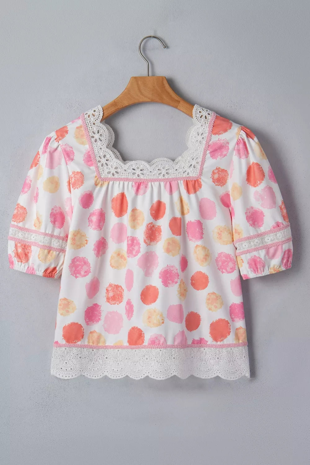White polyester blouse with pink, orange, and yellow polka dots, puff sleeves, square neckline, and lace trim.