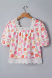 White polyester blouse with pink, orange, and yellow polka dots, puff sleeves, square neckline, and lace trim.