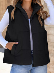 Black ribbed corduroy zip-up vest coat with stand collar and pockets.