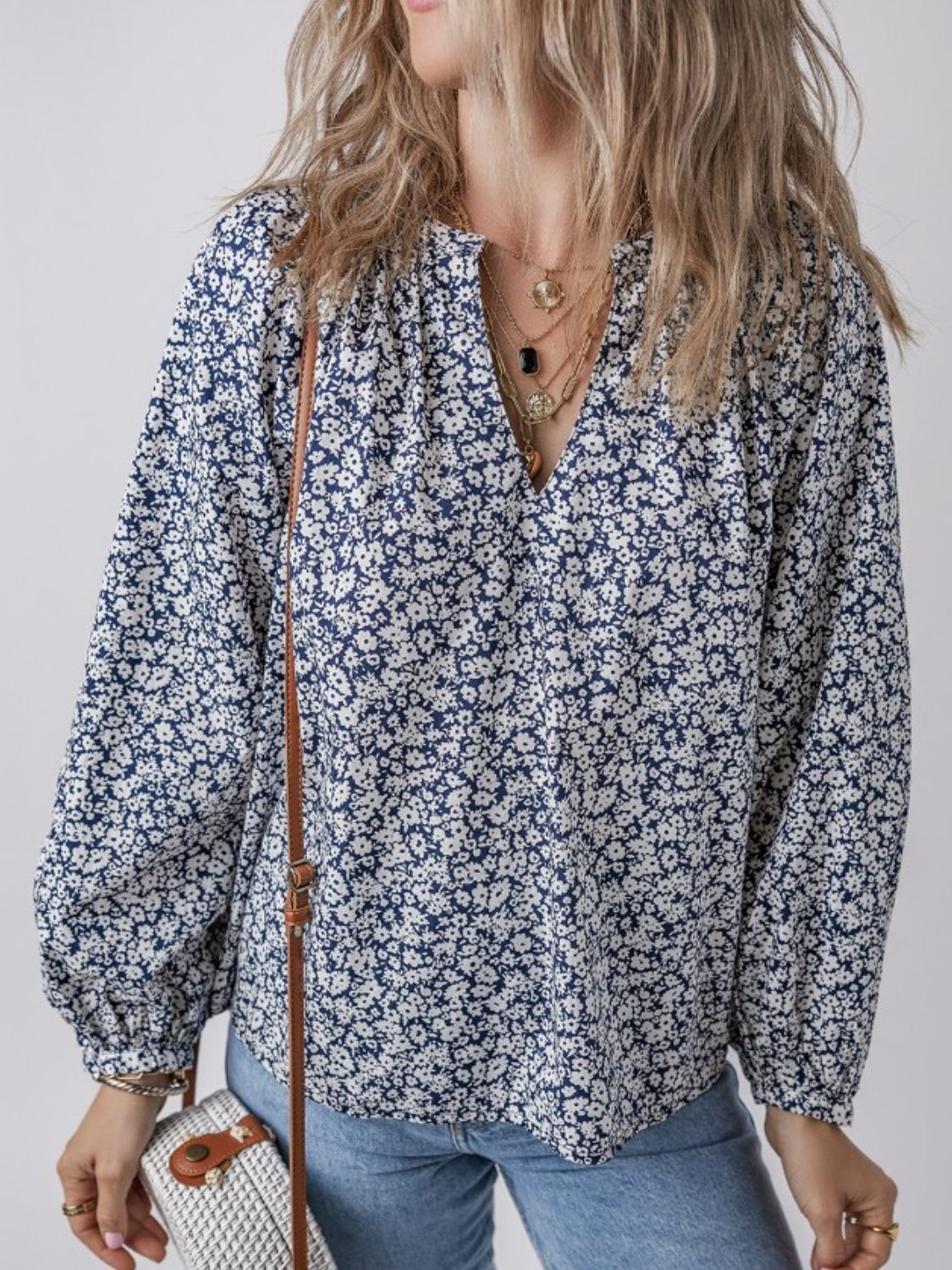 Navy floral print blouse with notched neckline and long sleeves