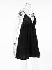 Black cotton tiered mini dress with lace trim and spaghetti straps