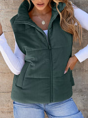 Green ribbed corduroy zip-up vest coat with stand-up collar and pockets.
