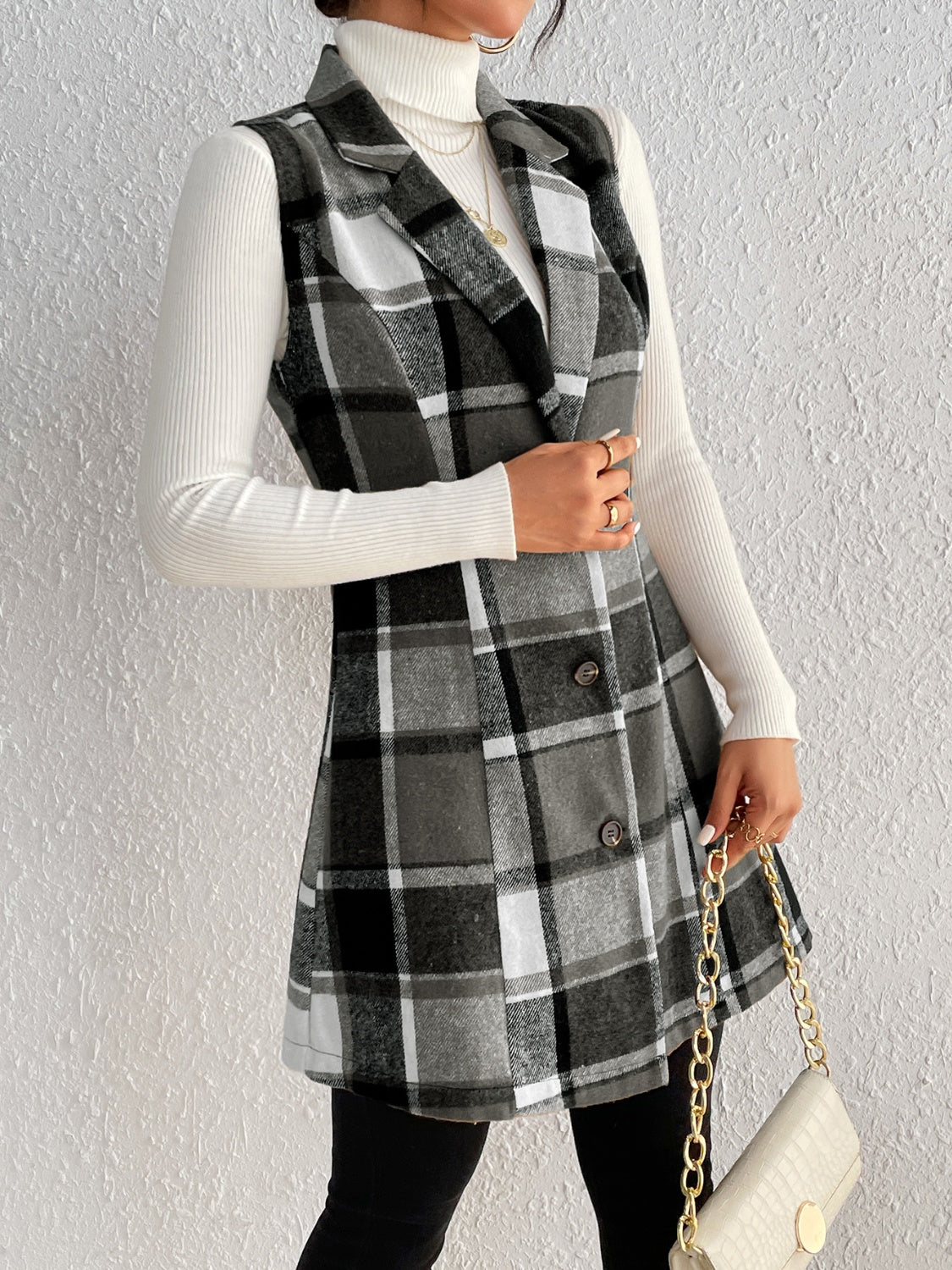 Sleeveless plaid blazer dress with button front and A-line skirt, styled with a white turtleneck.