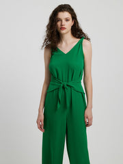 Emerald tie-waist wide leg jumpsuit with V-neck and sleeveless design.