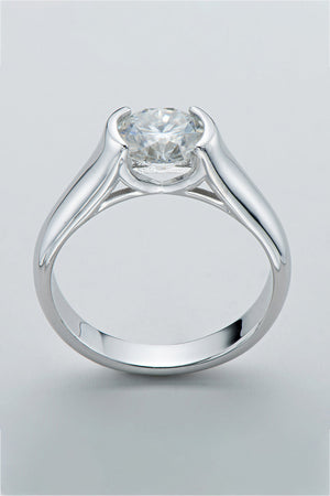 Silver platinum ring with a bezel-set round moissanite solitaire diamond.