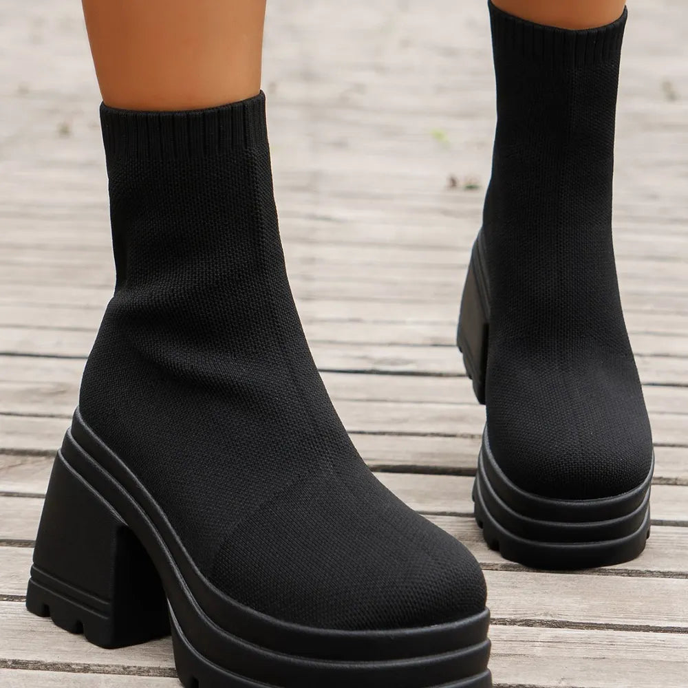 Black knit sock boots with chunky platform and block heel.