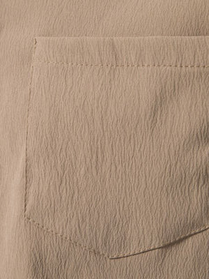 Men's plus-size beige cotton button-up shirt with textured fabric and chest pocket.