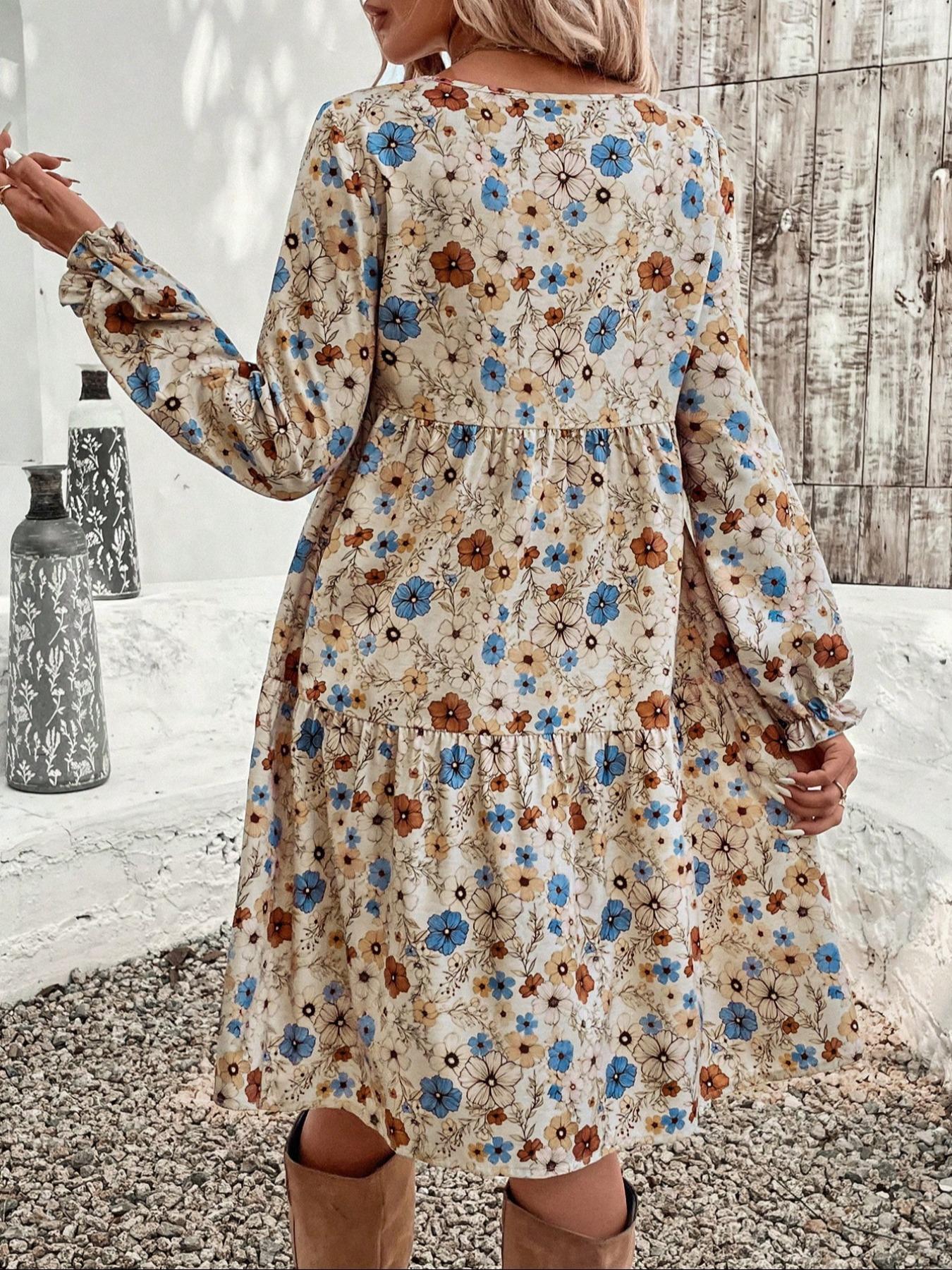 Charming floral tiered midi dress with long sleeves in beige with blue and brown flowers.