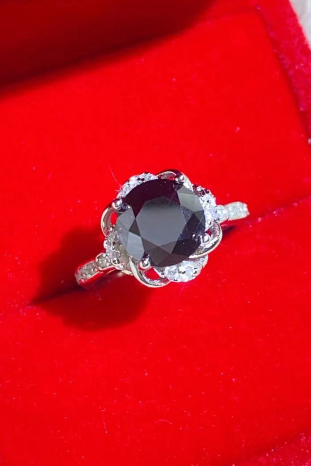 Black moissanite ring with diamond halo and floral setting