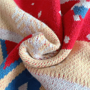 Festive Fair Isle knit jumper in red and cream with blue accents, acrylic fabric.