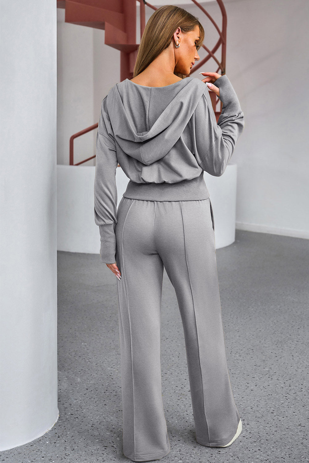 Dark gray cropped hoodie and wide leg lounge pants set with drawstring waist and cuffed sleeves.