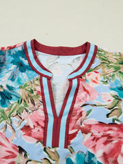 Women's cotton V-neck blouse with a floral print and striped trim detail.
