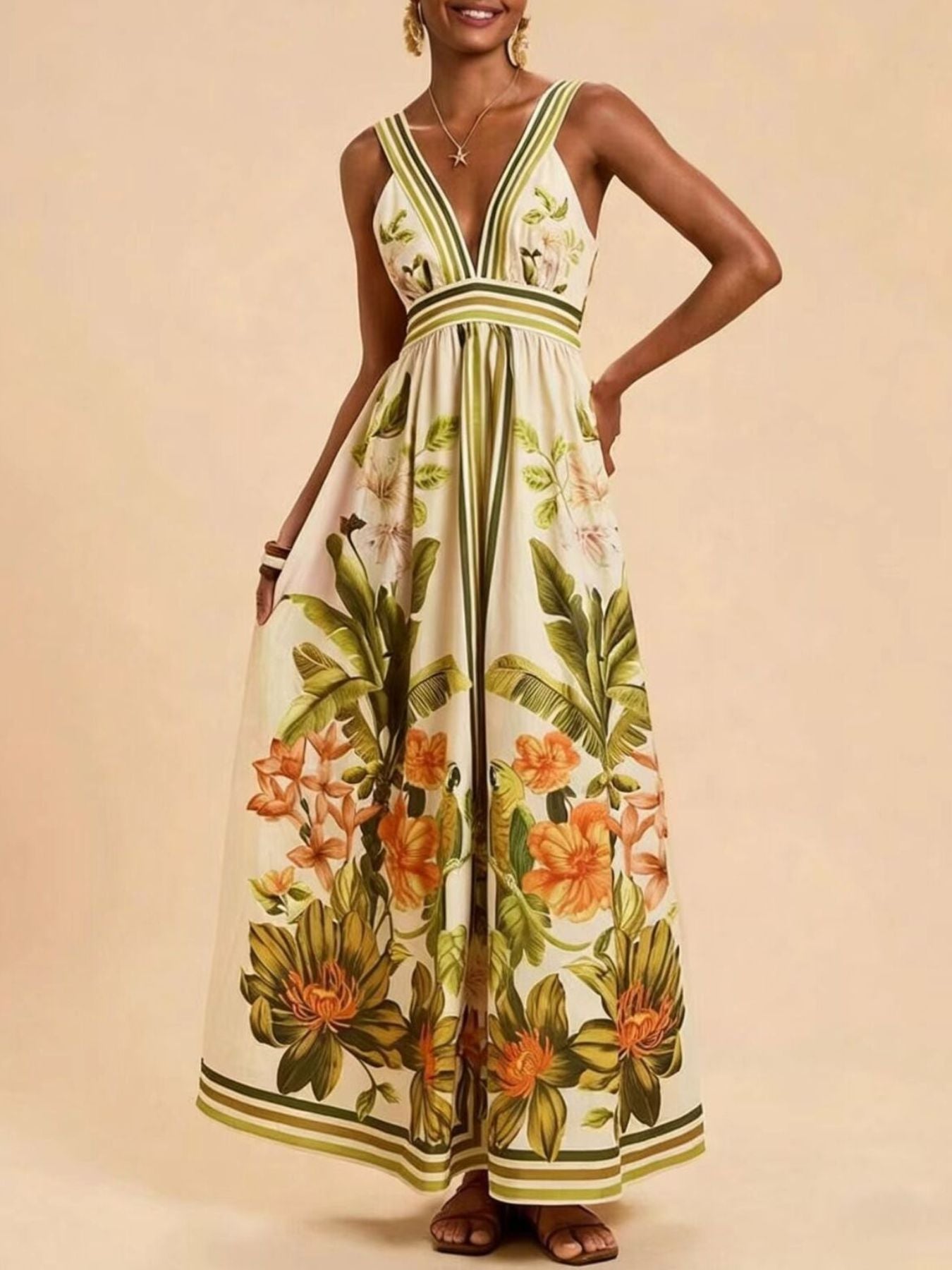 Tropical leaf print maxi dress with deep V-neck and empire waist.
