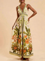 Tropical leaf print maxi dress with deep V-neck and empire waist.