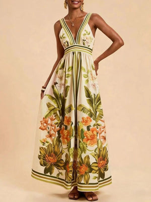 Tropical leaf print maxi dress with deep V-neck and empire waist.