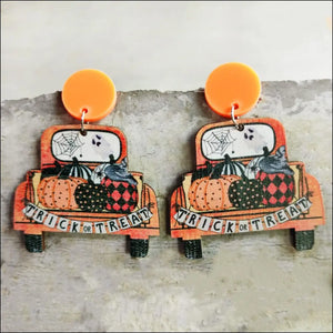 Spooky teacher statement earrings with orange trucks, pumpkins, and trick or treat banner.