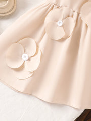 Off-white baby dress with 3D flower appliqués and white buttons.