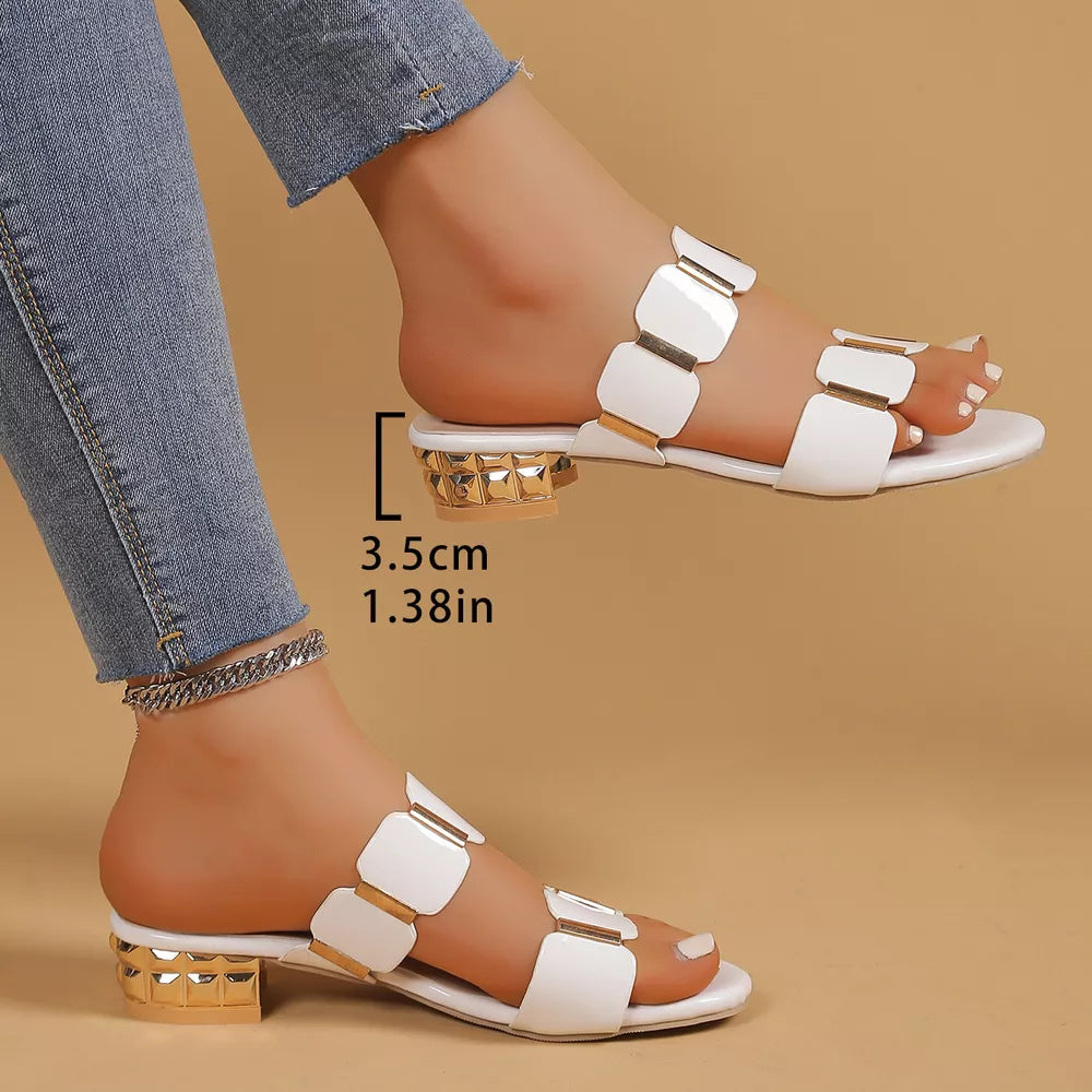 White block heel sandals with gold square accents and a textured gold block heel.