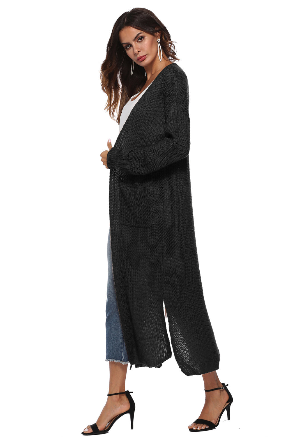Longline knit cardigan in black with side slits and pockets.