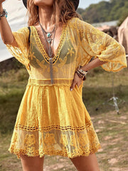 Gold lace tiered mini dress with V-neck and bell sleeves, styled as a cover-up.