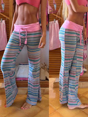 Relaxed drawstring striped pants with pink waistband and flared leg.