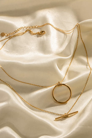 Gold double-layered necklace with geometric circle and bar pendants
