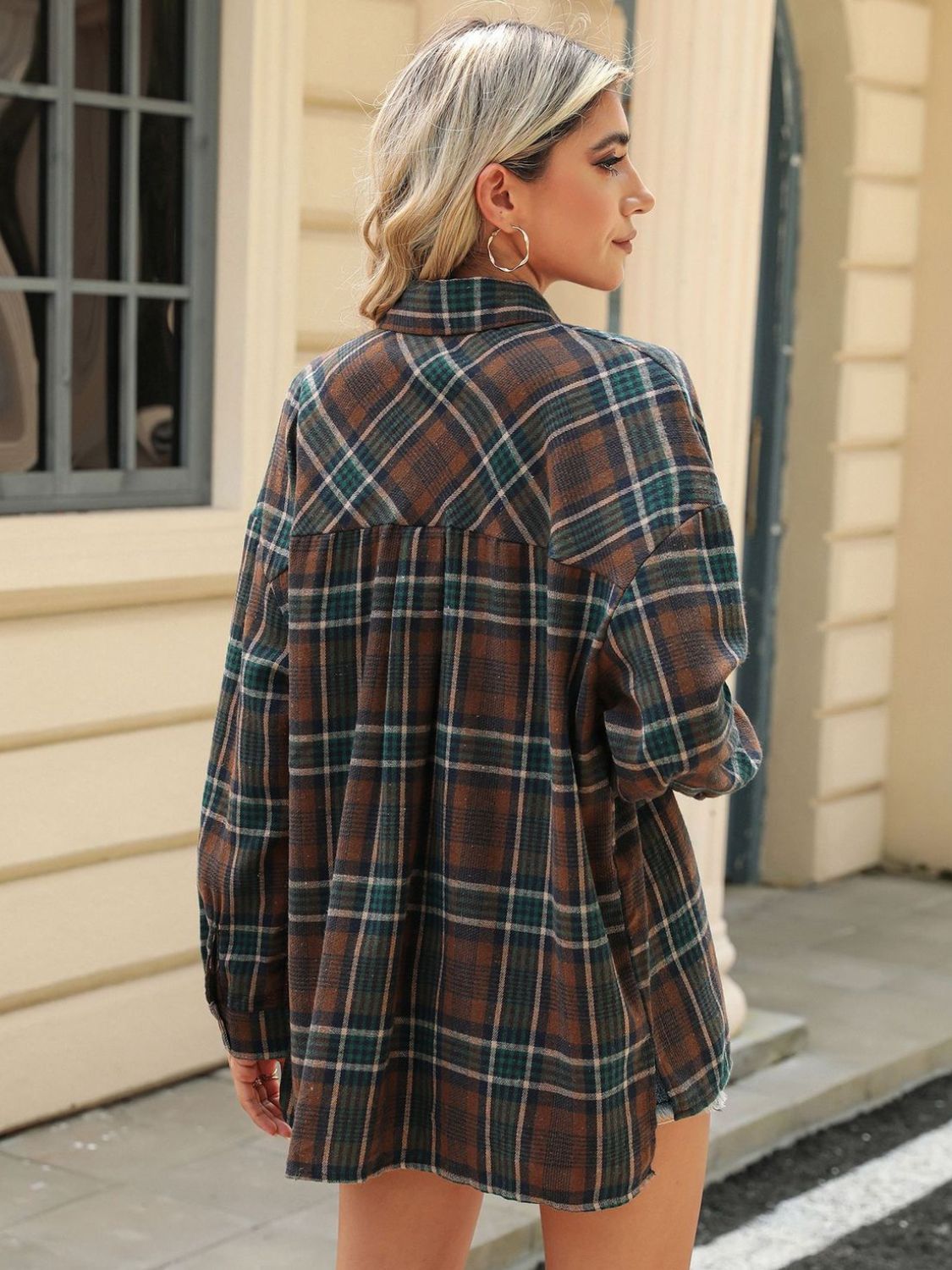 Brown plaid collared long sleeve shirt with button-down front and chest pockets.