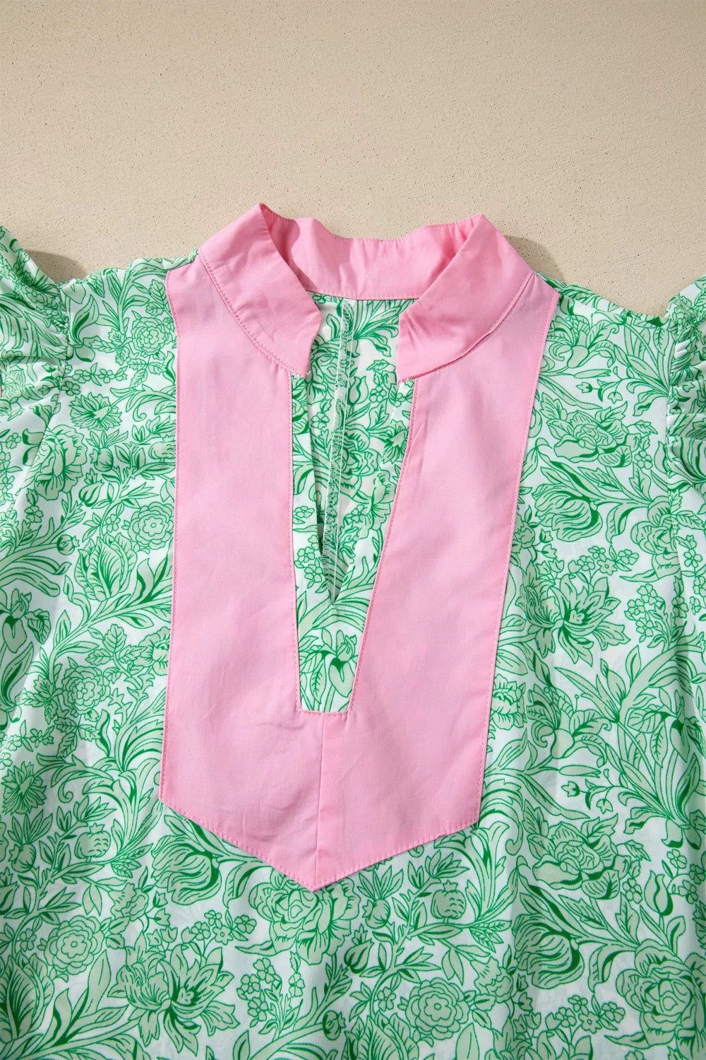 Botanical print midi dress with pink collar and placket, flutter sleeves.