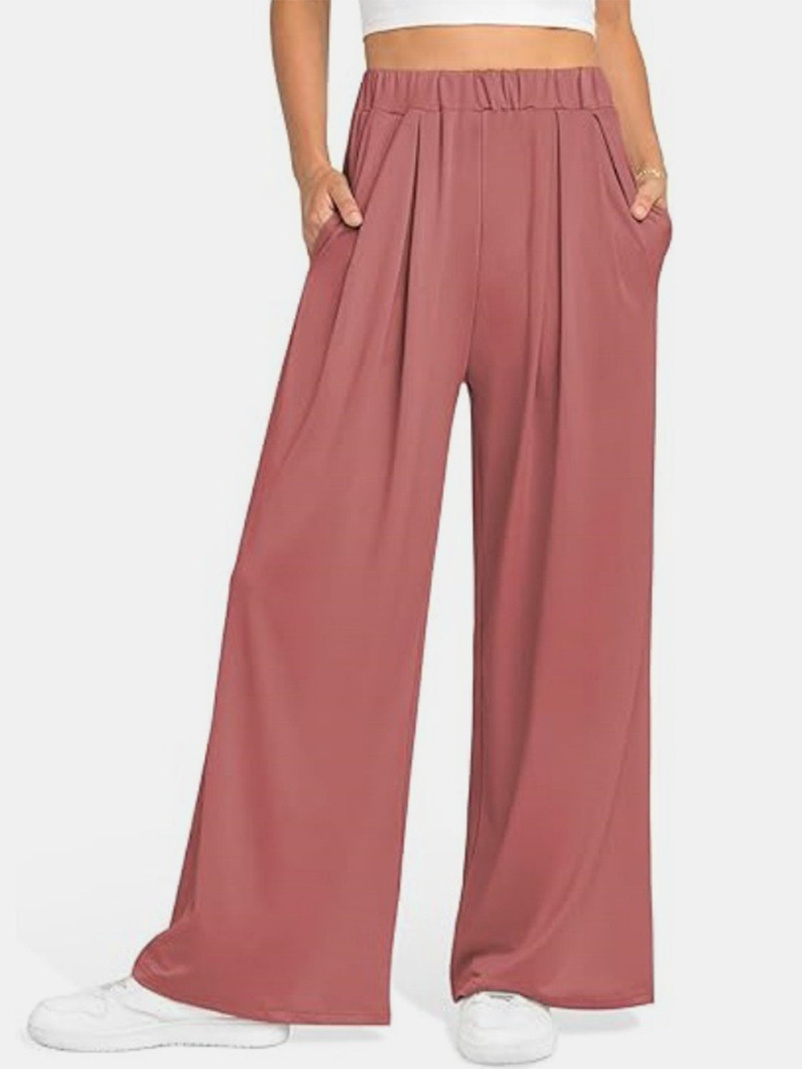 Pleated palazzo trousers with pockets in burnt coral.