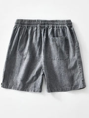 Relaxed fit men's gray drawstring shorts with a back pocket and vertical texture.