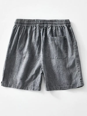 Relaxed fit men's gray drawstring shorts with a back pocket and vertical texture.