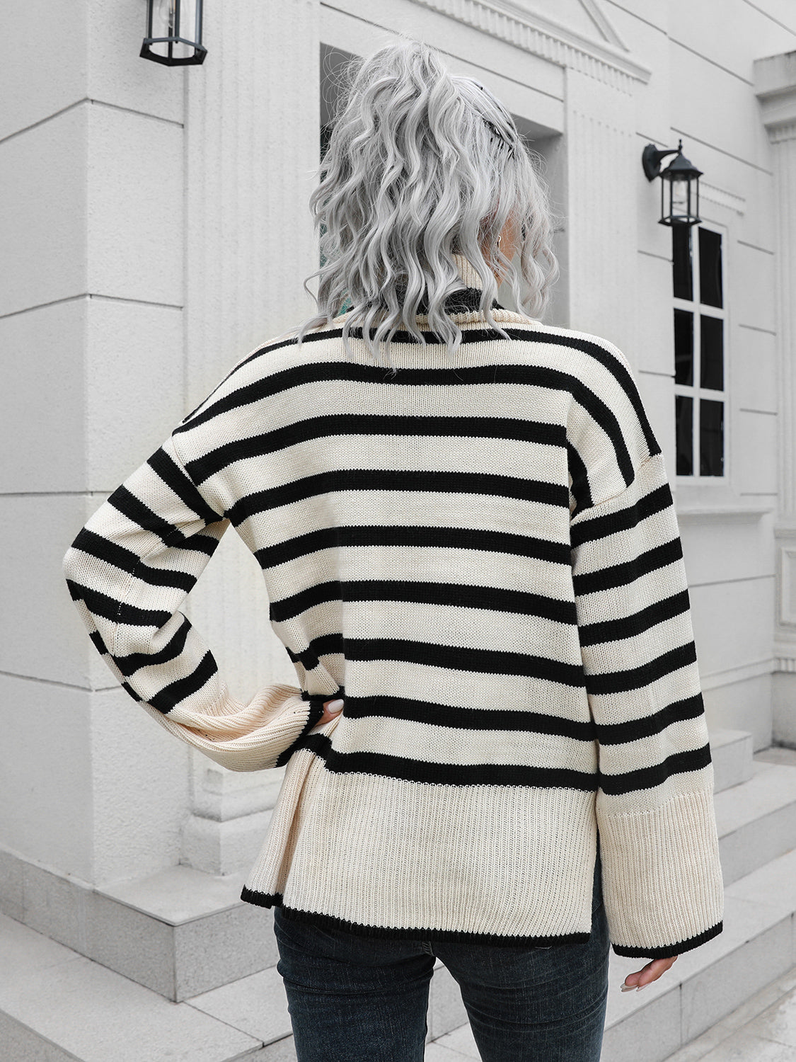 Flared sleeve striped turtleneck sweater in black and cream acrylic with a relaxed fit.