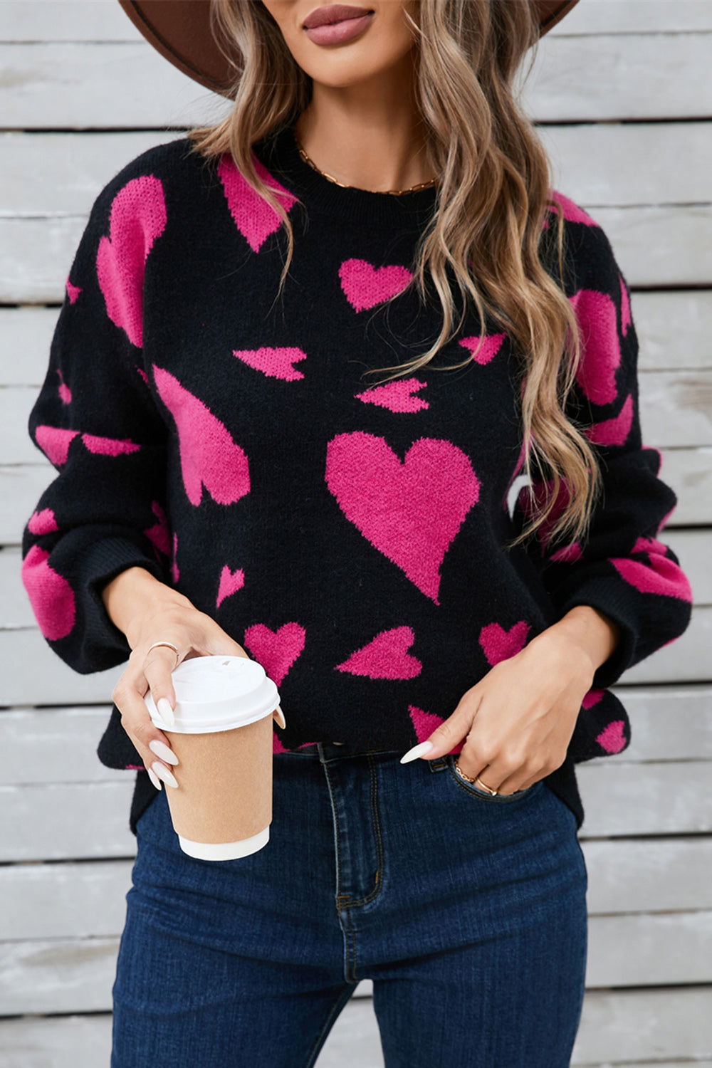 Black intarsia knit jumper with pink hearts, crew neck, long sleeves, acrylic blend.