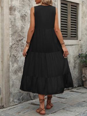 Black tiered midi sundress with button detail and sleeveless design.