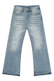 Baggy distressed denim jeans in medium wash with raw hem detail and whiskering.