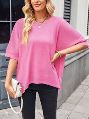 Pink relaxed fit t-shirt with drape sleeves and crew neck, styled with black jeans.