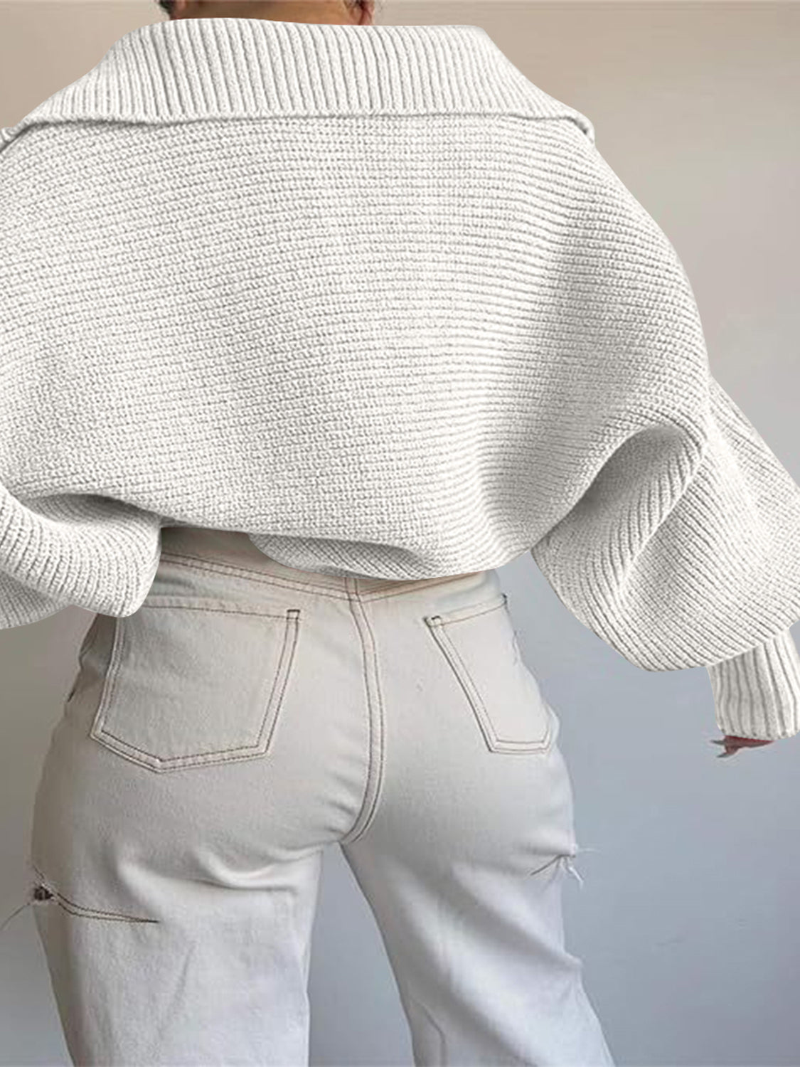 White wide collar balloon sleeve knit sweater with ribbed texture.