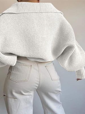 White wide collar balloon sleeve knit sweater with ribbed texture.