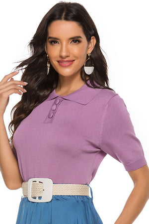 Button-down knit polo top in lilac with short sleeves and a collared neckline.
