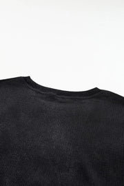 Black ribbed crewneck sweatshirt with a subtle heart outline detail.